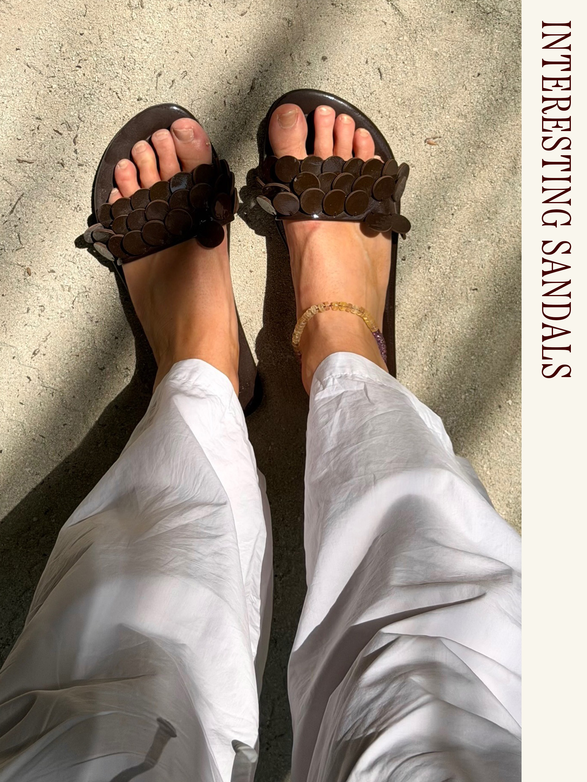 Influencer wearing white poplin pants and embellished sandals.
