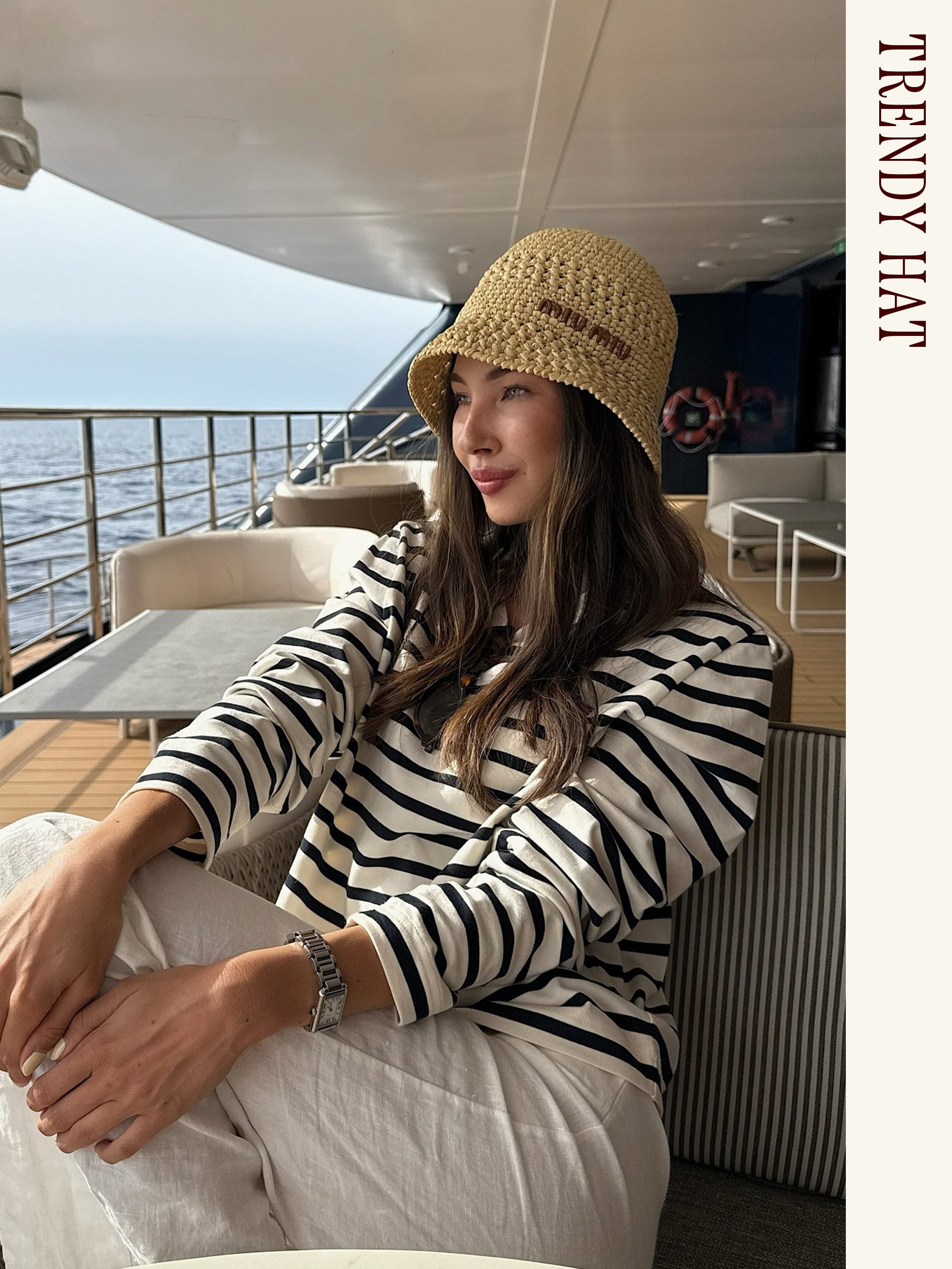 Influencer wearing a Miu Miu raffia bucket hat with a striped shirt and white pants.